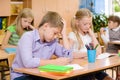 Group of elementary school pupils takes the test in class