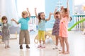 Group of emotional friends with their hands raised. Kids have fun pastime in daycare