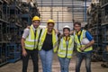 Group of employees and engineers in industrial plants. Team of workers and engineer celebrating in parts warehouse