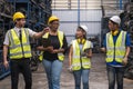 Group of employees and engineers in industrial plants. Workers working and discussing manufacturing plan in the factory Royalty Free Stock Photo