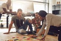 Group of employees meeting around notes on floor