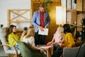 Group of employees, men and women, having meeting, discussion of future company plans and strategies at the office Royalty Free Stock Photo