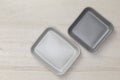 Group of empty blank ceramic square plates on white stone blackground