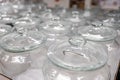 A group of empty cans with a lid. Rows of glass containers in a store. Close-up.