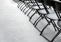 A group of empty folding chairs arranged in a row in a conference room Royalty Free Stock Photo