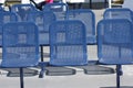 A group of empty metal seats.