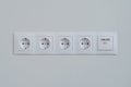 Group of empty white electrical european outlet located on gray wall - close up Royalty Free Stock Photo