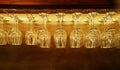Group of empty wine glasses hanging on bar rack in vintage filter background Royalty Free Stock Photo