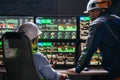 Group of engenners following production line using computer screens with Industry 4.0. Couple of factory operators controll