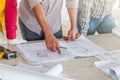 Group of engineer checking the blueprint on table and talking about construction project with commitment to success at Royalty Free Stock Photo