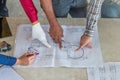 Group of engineer checking the blueprint on table and talking about construction project with commitment to success at Royalty Free Stock Photo