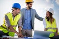 Group of engineers, architects, business partners at construction site working together Royalty Free Stock Photo