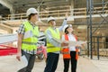 Group of engineers, builders, architects on the building site. Construction, development, teamwork and people concept Royalty Free Stock Photo