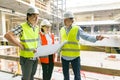 Group of engineers, builders, architects on the building site. Construction, development, teamwork and people concept Royalty Free Stock Photo