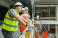 Group of engineers, builders, architects on the building site. Construction, development, teamwork and people concept Royalty Free Stock Photo