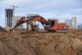 Group of the excavators for dig ground trenching at a construction site for foundation and installing storm pipes Royalty Free Stock Photo