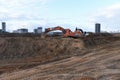 Group of the excavators for dig ground trenching at a construction site for foundation and installing storm pipes Royalty Free Stock Photo