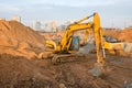 Group of the excavators for dig ground trenching at a construction site for foundation and installing storm pipes. Royalty Free Stock Photo