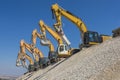 Group of excavators on gravel hill