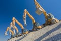 Group of excavators on gravel hill