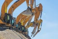 Group of excavators on gravel hill