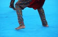 Group of excited African folk dancers, wearing traditional clothing, performing a vibrant dance Royalty Free Stock Photo