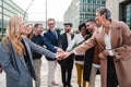 Group of excited business people stacking hands to celebrate a success or achievement. Corporate team work cooperation Royalty Free Stock Photo