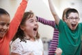 Group Of Excited Children At Stage School Enjoying Dance Class Together