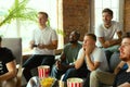 Group of excited friends playing video games at home Royalty Free Stock Photo