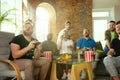 Group of excited friends playing video games at home Royalty Free Stock Photo