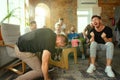 Group of excited friends playing video games at home Royalty Free Stock Photo