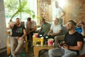 Group of excited friends playing video games at home Royalty Free Stock Photo