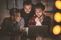 Group of excited friends watching photos on a tablet together