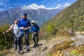 Group of excited hikers walking on mountain trail Royalty Free Stock Photo