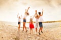 Excited teens jumping and having fun on the beach