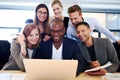 Group of executives gathered around laptop Royalty Free Stock Photo