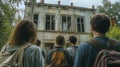 Group of explorers approaches an abandoned building surrounded by greenery on a cloudy day Royalty Free Stock Photo
