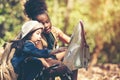 Group family children checking map for explore and find directions in the camping jungle nature and adventure.