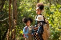 Group family children checking map for explore and find directions in the camping jungle nature and adventure. Royalty Free Stock Photo