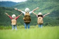 Group family children travel nature trips raise arms and standing see mountain outdoors,