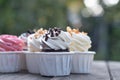 Group of fancy cup cakes on wooden table, birthday celebration concept