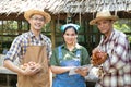 A group of farmers are carrying chickens and eggs, along with a tablet device standing