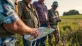 A group of farmers gather around a map discussing the placement of furrow irrigation systems in their biofuel