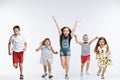 Group fashion cute preschooler kids friends posing together and looking at camera white background