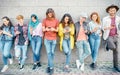 Group of fashion friends watching on their smart mobile phones - Millennial generation z addicted to new technology trends Royalty Free Stock Photo