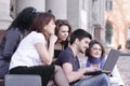 Group of fellow students with books and laptop Royalty Free Stock Photo