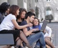 Group of fellow students with books and laptop Royalty Free Stock Photo