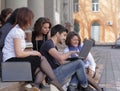 Group of fellow students with books and laptop Royalty Free Stock Photo