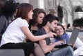 Group of fellow students with books and laptop Royalty Free Stock Photo