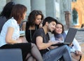 Group of fellow students with books and laptop Royalty Free Stock Photo